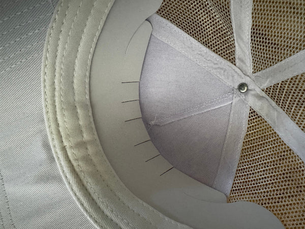 Inside view of adjustable white baseball cap showing comfortable fit and sizing mechanism
