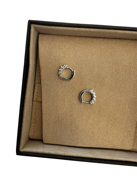 Elegant lifestyle photo of gold vermeil pearl huggie earrings being worn