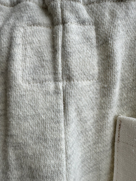 Close-up details of You The Brave grey sweatpants fabric and construction
