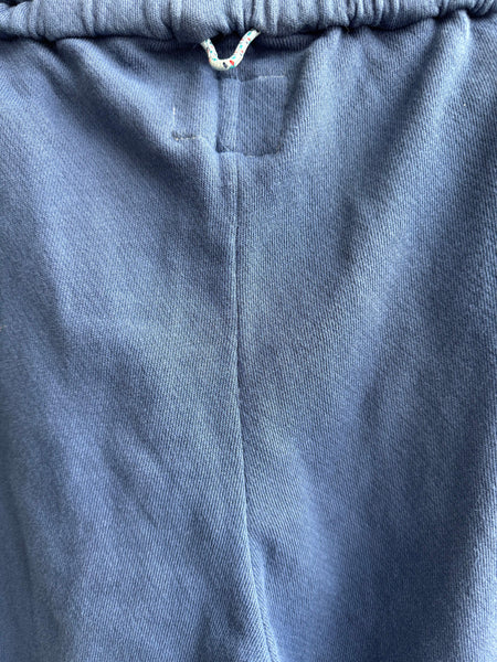 Close-up details of charcoal blue jogger fabric and construction