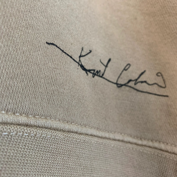 Model wearing Kurt Cobain tan sweatshirt skeleton design unisex fit